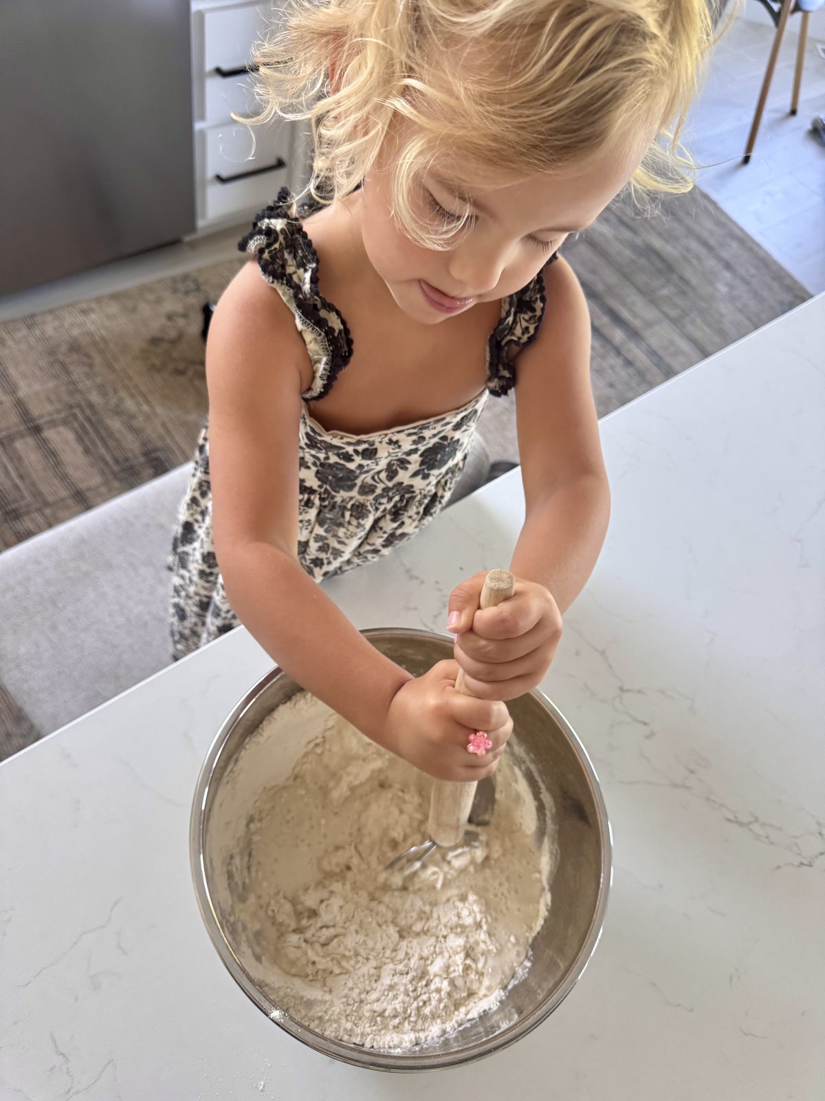 Emery helping mix sourdough pizza dough