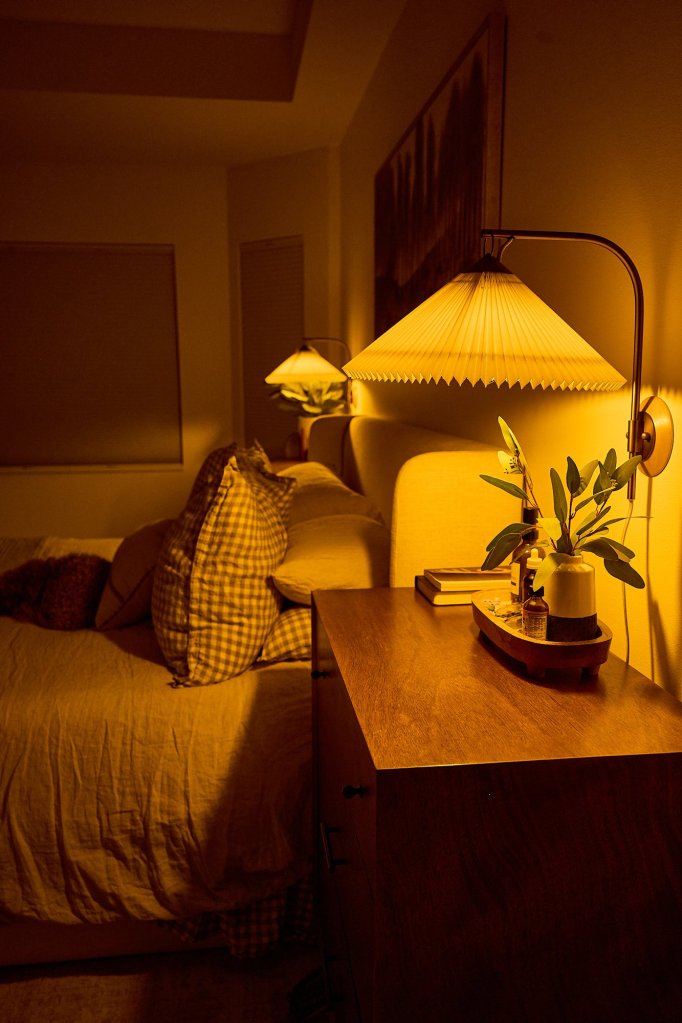 Cozy warmly-lit bedroom setting the mood for winter self-care habits