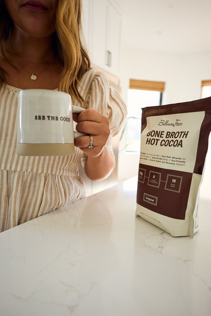 Ballerina Farm bone broth hot cocoa mug on the counter with a See The Good mug